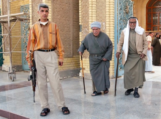 A man guards the Abu Hanifa mosque on Friday in the Azamiyah neighborhood of Baghdad, Iraq. Neighborhood watch groups sprung up after the Feb. 22 bombing of a revered Shiite shrine in Samarra.