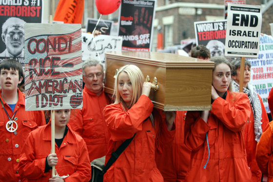Protesters carry a coffin towards the Ph