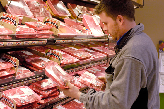 Dan Hogan, 32, looks for a good cut at the Cub Foods grocery store in Burnsville, Minn., on March 29.