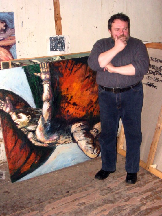 Lev Tabenkin, a painter in Moscow, stands in front of some of his canvasses at a temporary studio. He lost possession of his old studio after the ownership was transferred without his knowledge.