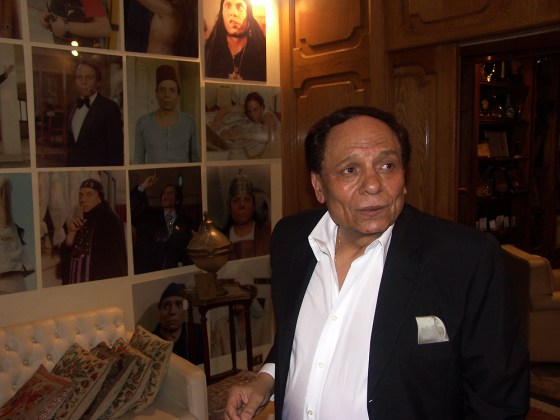 Adel Imam at home in front of portraits of him from movie roles that have made him Egypt's and the Middle East's best known comic.