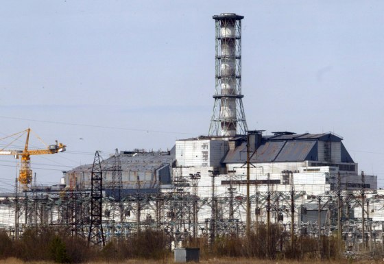 A chimney towers over the sarcophagus that covers destroyed Reactor No. 4, left, with Reactor No.3 on the right, at Ukraine's Chernobyl nuclear power plant on April 22, 2006.