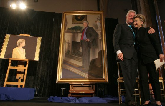 Former President Bill Clinton and Sen. Hillary Clinton (D-N.Y.) with their portraits.