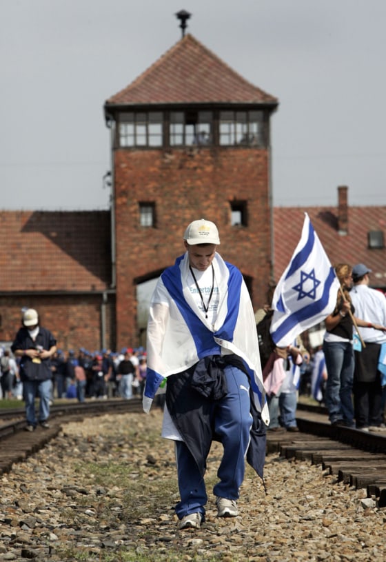 Youth walks in front of main railway building of former Nazi death camp of Birkenau in Oswiecim