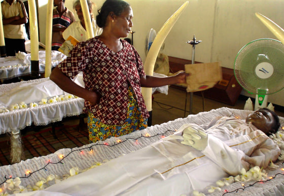 Chandrawathi, mother of 16-year old Lalith Bandara, grieves Tuesday during the boy's funeral at a Buddhist temple in Kalyanipura, a village near Trincomalee, northeast of Colombo, Sri Lanka.