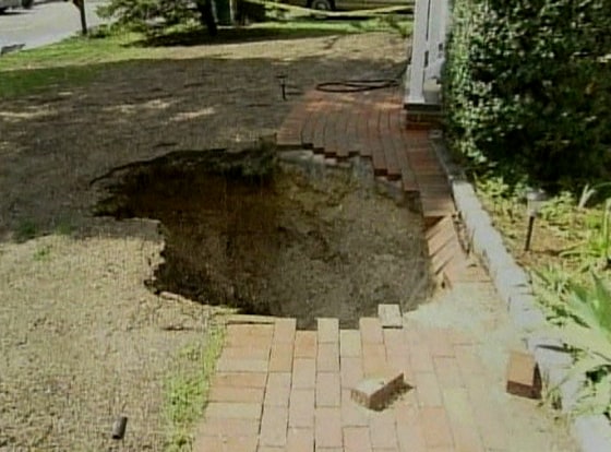The front walk at Andrew Palladino's house in Huntington, N.Y., collapsed into the cesspool Sunday along with Palladino as he went out to retrieve his newspaper.