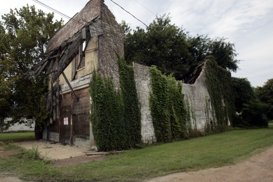 Vines and warning signs cover the walls of the two-story, whitewashed brick building that was Bryant's Grocery & Meat Market in Money, Miss., in this 2005 photo. The store is where Emmett Till, a 14-year-old black youth, whistled at the owner's white wife and paid for the act with his life in August 1955.