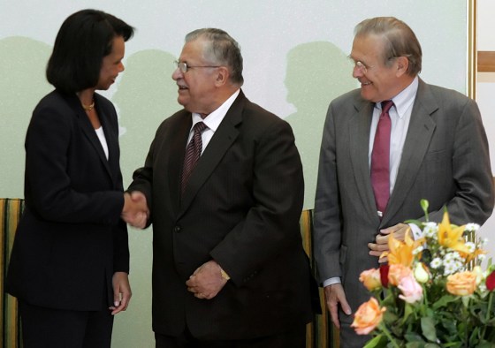 US Defence Secretary Rumsfeld looks on as US Secretary of State Rice shakes hands with Iraqi President Talabani in Baghdad