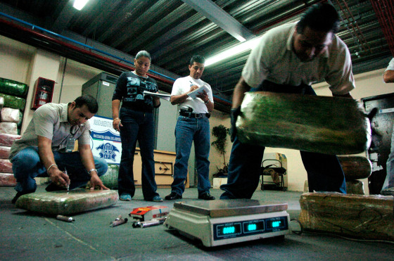 Mexican federal attorneys and police agents weigh and catalog packages of marijuana, which were seized in a raid in September in Tijuana, Mexico. Small amounts of drugs for personal use are set to be decriminalized.