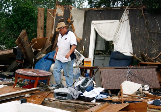 Dennis Lea walks through what's left of his home Wednesday in Westminster, Texas, after it was hit by a tornado overnight.