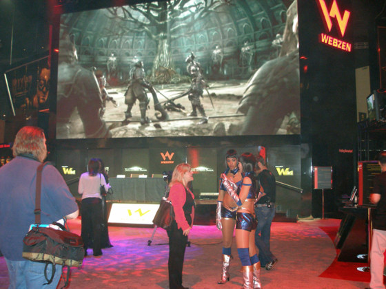 The ever-present "booth babes" talk with an E3 attendee at the Webzen booth at E3 in Los Angeles. While the rules called for more modesty than last year, there was no shortage of exposed skin.