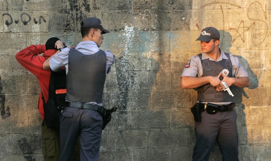 Police officers frisk a gang suspect Thursday at a checkpoint in Sao Paulo, Brazil. 