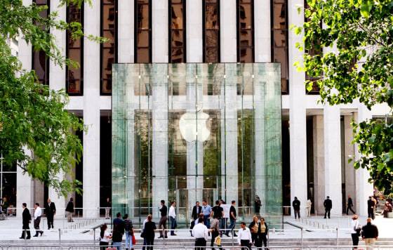 People gather around the glass entrance to the new Apple store on New York's fashionable Fifth Avenue on May 18. This is the California computer company's second New York retail store.