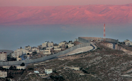 A section of Israel's separation barrier is seen on a hill between the West Bank village of Abu Dis and Jabel Mukaber on the edge of Jerusalem. As America contemplates construction of a massive fence along the Mexican border, it can look to Israel as a test case.