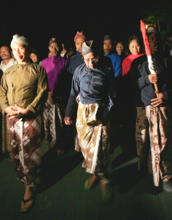 Wearing traditional dress, Maridjan, center, the spiritual guardian of Mount Merapi, and other villagers&nbsp;circle their village late Thursday night as a part of a&nbsp;prayer for protection from the rumbling volcano.&nbsp;The men later asked journalists to leave and it was reported that they removed their clothes as part of&nbsp;the ritual.&nbsp; 
