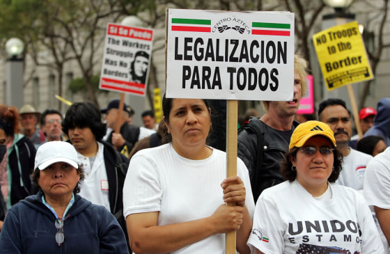 Demonstrators attending a pro-immigration rally in San Francisco hold signs in Spanish,&nbsp;including one which reads "Legal status for all.'' Linguists and historians say the current immigration debate and proposals to make English the official language of the U.S. resemble other linguistic struggles across the globe.