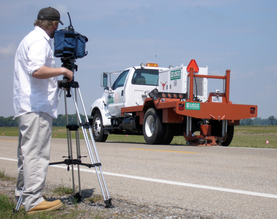 A cameraman videotapes a "vibe truck" moving along an Arkansas highway on May 16 to measure sediment in the area for evidence of past earthquakes in the New Madrid seismic zone.