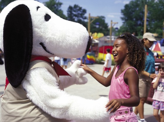 Snoopy greets a girl at Cedar Point amusement park's Camp Snoopy.