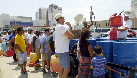 People wait in line to buy gas from Mich