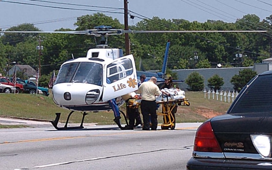 One of the victims of the incident in the parking lot of an McDonald's restaurant in Covington, Ga. is airlifted Tuesday for transport to a hospital.
