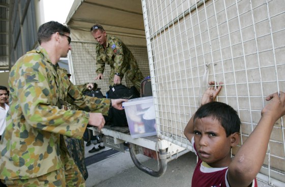 BOY AND AUSTRALIAN TROOPS