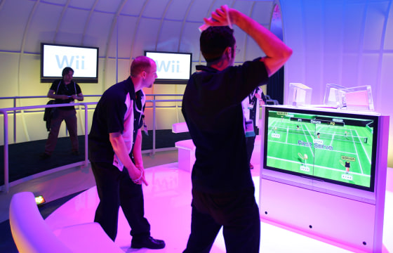 Nintendo game demonstrators play tennis