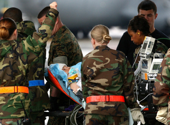 US Air Force medical personnel carry CBS correspondent Dozier into an ambulance bus at Ramstein airbase