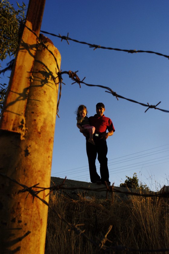 Nuaman village resident Khader Darawi, seen here with his nephew, is caught between two worlds, not belonging to either Bethlehem or Jerusalem.