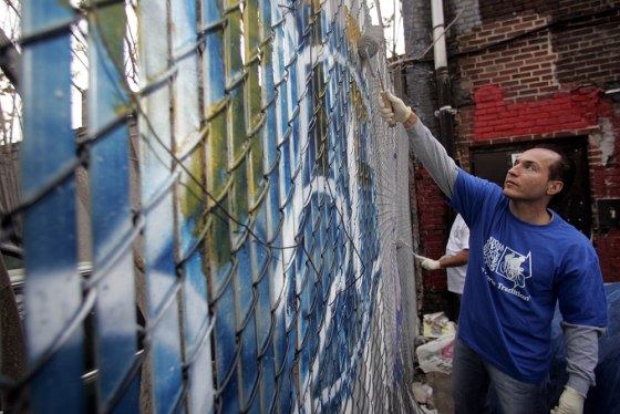City Councilman Peter Vallone Jr., paints over graffiti in the Queens borough of New York on May 2. Since Vallone was elected in 2001, graffiti has become his signature issue.
