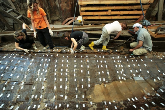 Turkish archaeologists and restorers work on remains of a tenth century Byzantinian ship in Istanbul