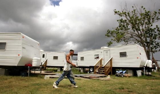 Shrimp boat deck-hand Gilhang walks past neighbors' FEMA trailers after taking break from work in Venice, Louisiana