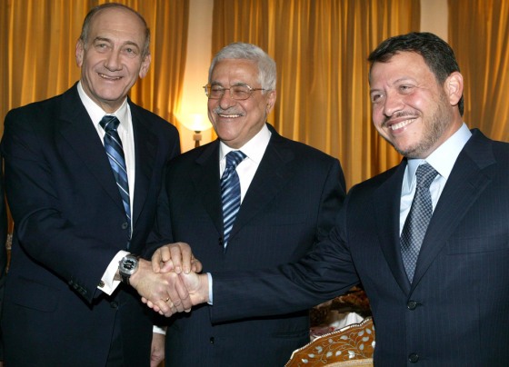 King Abdullah of Jordan shake hands with Palestinian President Abbas and Israeli MP Olmert in Petra