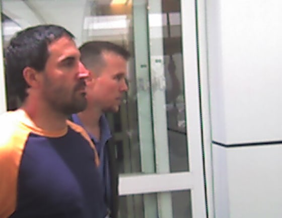 Darren Mack, seen in custody at Dallas-Fort Worth Airport, was caught after failing to turn himself in Thursday.