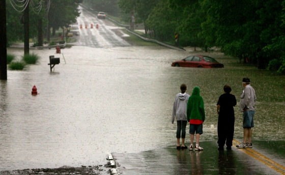 Flooding like this street in Bedford Heights, a Cleveland suburb, cut off areas across Ohio on Thursday.