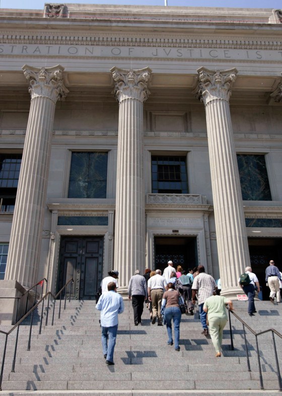 Members of a jury pool enter the criminal court building in New Orleans