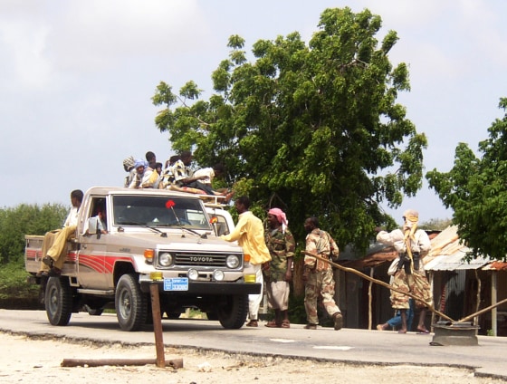 Members of the Islamic Courts Union search a truck at a checkpoint they took over from the Habar Gidir clan after a fire fight broke out between the two groups in Mogadishu, Somalia.