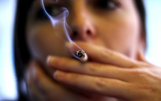Woman smokes a cigarette in a bar in Palma de Mallorca