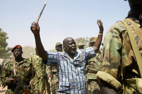 John Garang, then leader of the Sudan People's Liberation Army, is surrounded by soldiers as he waves at the crowd in a January 2005 file photo in southern Sudan. From Africa to Indonesia, the number of wars worldwide has dropped to a new low, peace researchers report. But they say the face of conflict is changing.
