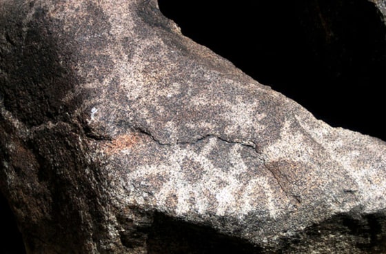 A petroglyph in White Tanks Regional Park in Arizona possibly depicting the supernova of A.D. 1006 (star symbol, right of center) and the constellation Scorpius (scorpion symbol, left of center). Prehistoric people carved desert varnish away, revealing lighter-colored rock underneat to create petroglyphs.