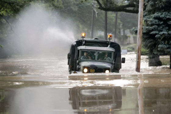 A truck borrowed from a military academy in Trenton, N.J., searches for stranded residents Thursday. Thousands of people along the Delaware River fled their homes.