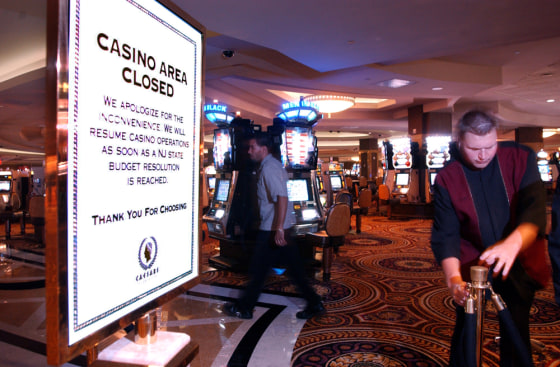 A casino worker closes off the casino floor at Caesar's Atlantic City casino on Wednesday.
