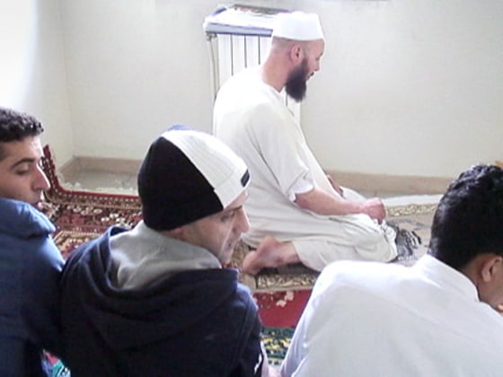 Self-designated imam Arafat Mahmoud, far center, leads an Islamic prayer as Hakimi Abd Elfattah, left, and other prisoners pray in a jail cell in the Bollate prison, on the outskirts of Milan, Italy.
