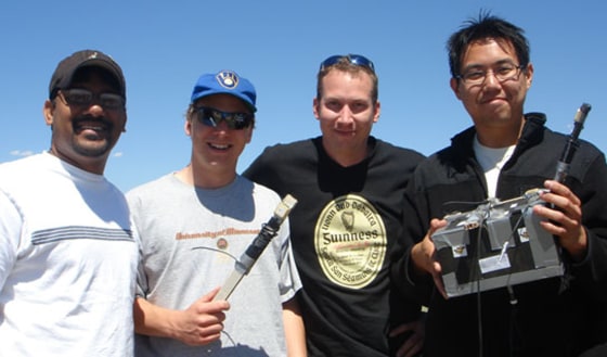 University of Minnesota students proudly display their Minnesat project after its high-altitude balloon flight. This team project evaluated use of Global Positioning System satellites to determine attitude of their payload package. 