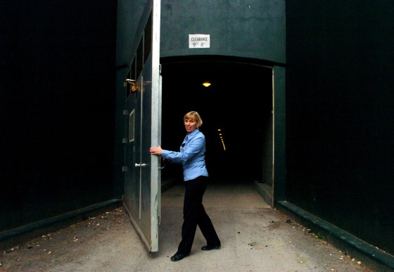 Linda Walls, manager of The Greenbrier's bunker tours, opens one of the giant doors leading to the long-secret fallout shelter built to house Congress after a nuclear attack.