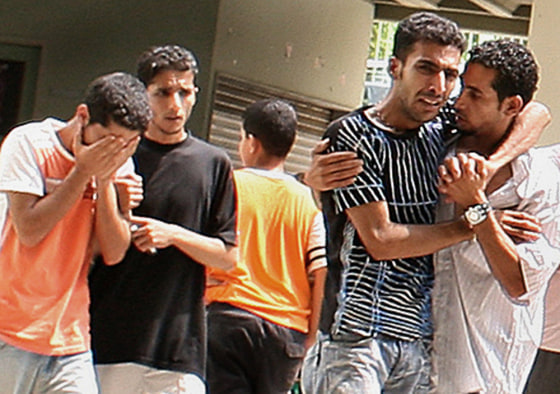 Two displaced Lebanese learn that their relatives have been killed by Israeli airstrikes in the south of the country. They heard the news on a television in the empty halls of a Beirut high school.
