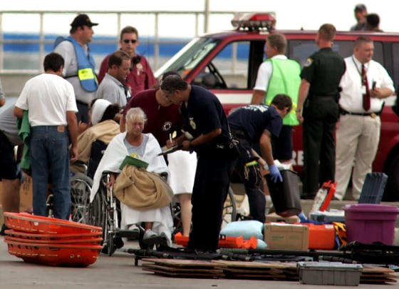 Injured passengers are attended to after being evacuated from the cruise ship Crown Princess in Cape Canaveral