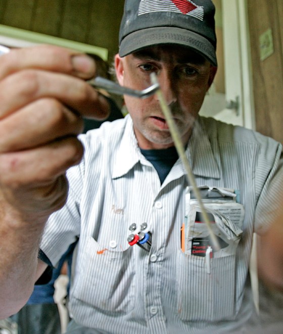 Ken Montsma takes bull semen to be thawed before inserting it in a cow on a farm near Fond du Lac, Wis. Artificial insemination is considered safer because temperamental bulls are kept away from cows.