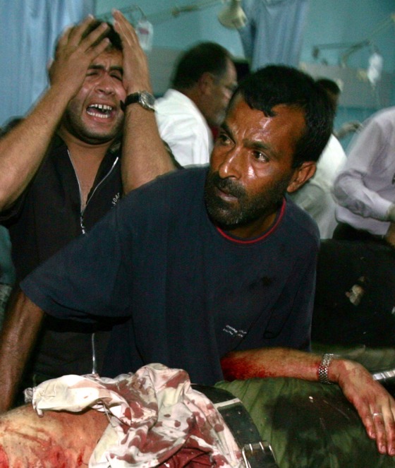 Palestinians react in front of dead militant killed during Israeli raid in Maghazi refugee camp in central Gaza strip