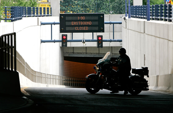 A Massachusetts State Police blocks the road leading to the Ted Williams tunnel in Boston on Thursday after State Engineers found two bolts holding ceiling panels that appeared to have slipped slightly.