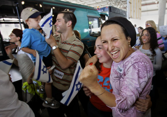 Nearly 230 immigrants from the U.S. and Canada react as they arrive at Ben Gurion Airport near Tel Aviv, Israel, Thursday.